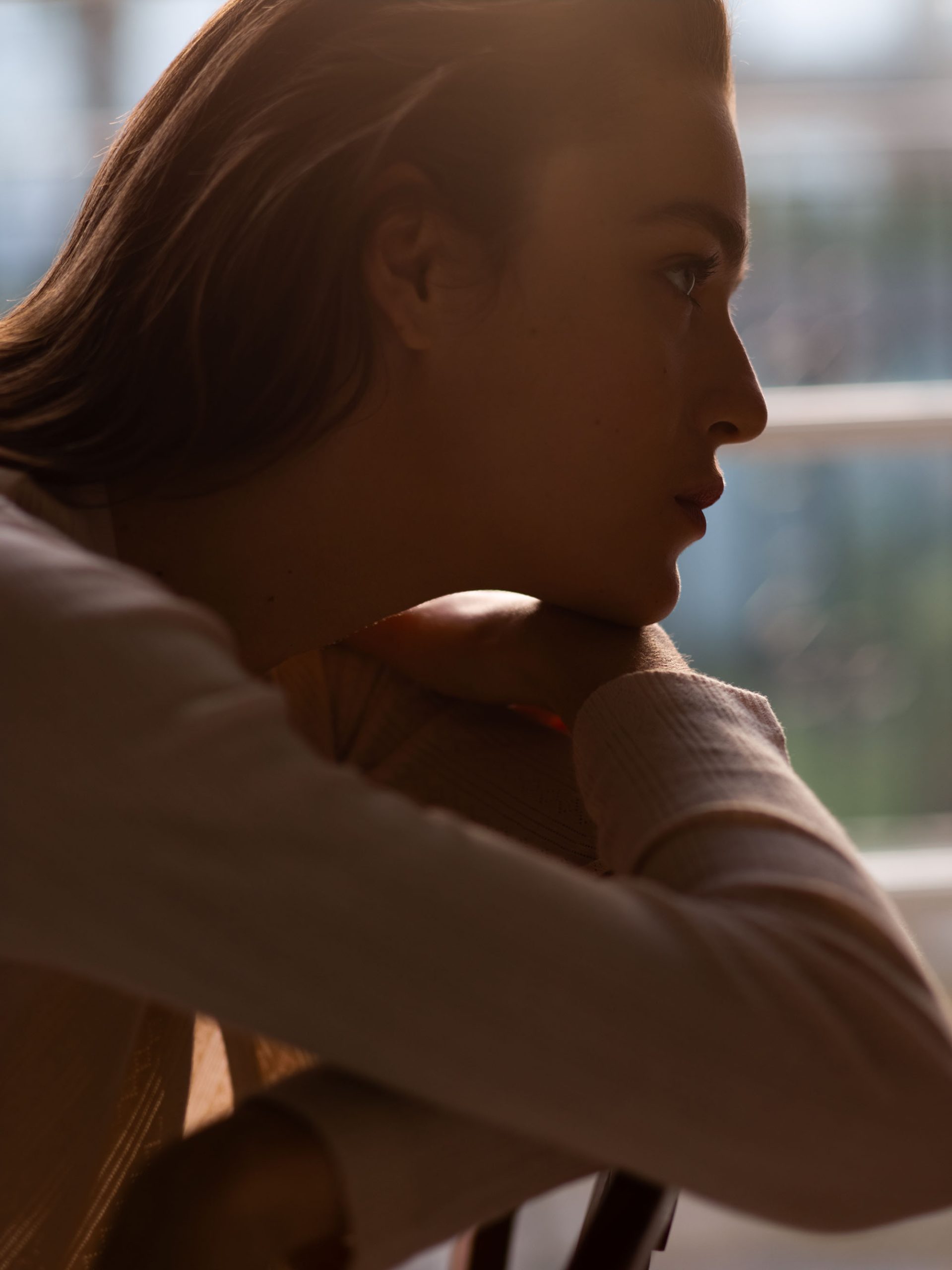 Phụ nữ ngồi chống cằm, làn da