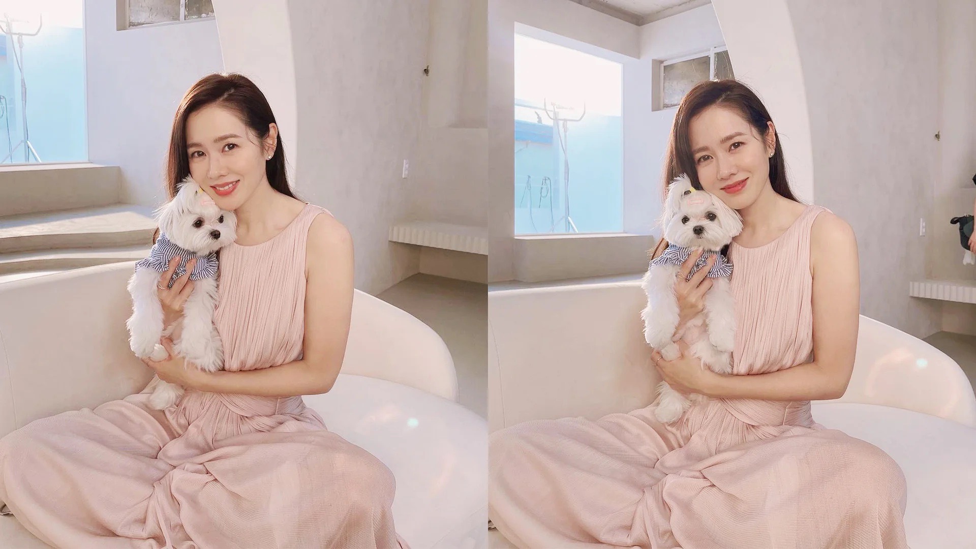 Son Ye Jin mặc đầm màu hồng phấn, ngồi trên ghế sofa và bế cún để chụp hình chân dung